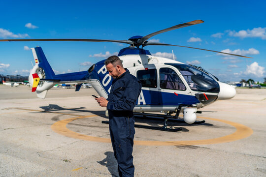 helicopter pilot looking at the route before takeoff