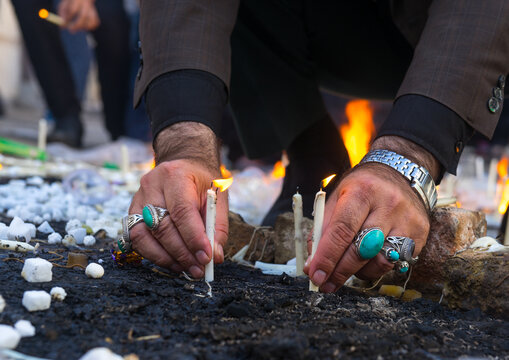 A man lights candles during chehel menbari to commemorate hussein, Lorestan, Khorramabad, Iran