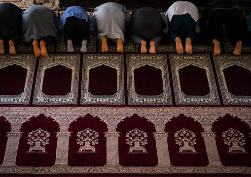 Iranian shiite  men kneeling and praying in mosque, Golestan province, Karim ishan, Iran