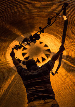 Iranian man training with kabbadeh chain and bow at saheb a zaman club zurkhaneh, Yazd province, Yazd, Iran
