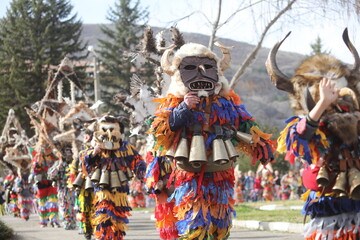 Zemen, Bulgaria - March 15, 2025: Masquerade festival Surva in Zemen, Bulgaria. People with mask called Kukeri dance and perform to scare the evil spirits.
