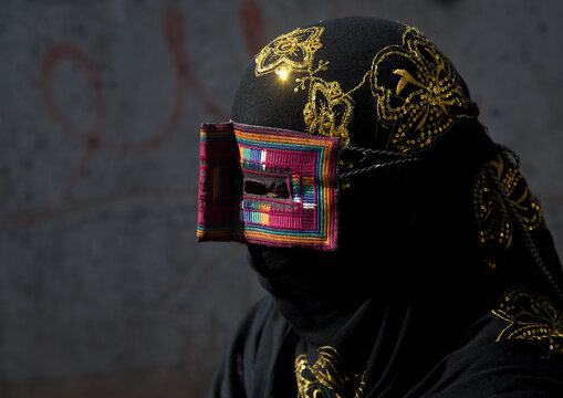 A bandari woman wearing the traditional mask called the burqa on a market, Hormozgan, Bandar abbas, Iran