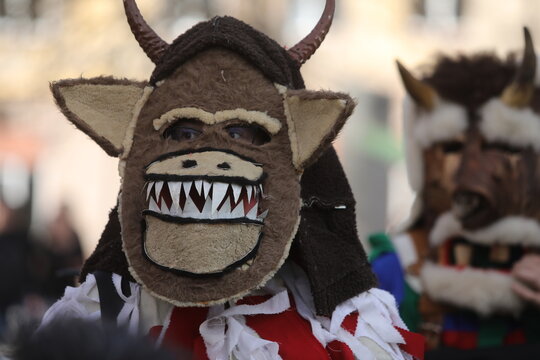 Zemen, Bulgaria - March 15, 2025: Masquerade festival Surva in Zemen, Bulgaria. People with mask called Kukeri dance and perform to scare the evil spirits.