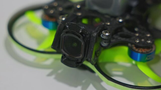 Close-up of FPV drone propellers slightly twitching during finder signal mode. Quadcopter beeper activation, electronic response and pre-flight diagnostic behavior. High quality 4k footage