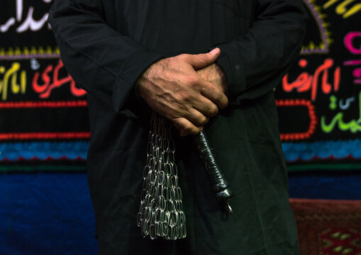 Iranian shiite muslim man with iron chains to commemorate Ashura, Central County, Theran, Iran