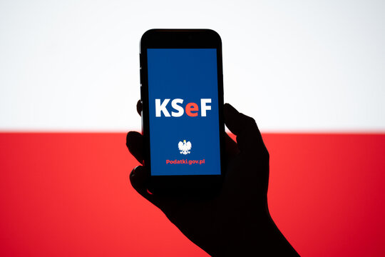 KSeF Krajowy System e-Faktur logo on smartphone, Polish flag in bg. Government e-Invoicing tax platform for issuing, receiving, storing structured invoices on February 17, 2026 in Krakow, Poland.