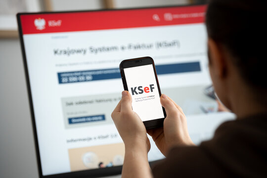 KSeF Krajowy System e-Faktur logo and website on a smartphone and computer screen. Government e-Invoicing tax platform for issuing, receiving invoices on February 17, 2026 in Krakow, Poland.