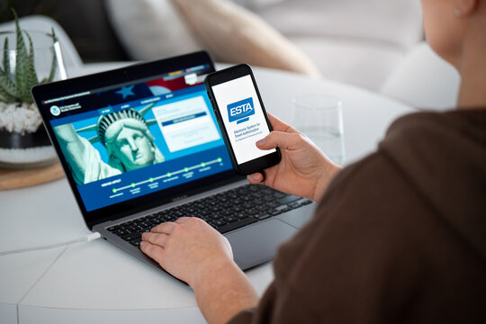 Woman holding smartphone with ESTA Electronic System for Travel Authorization logo, filling form to travel to the United States under the Visa Waiver Program on February 17, 2026 in Krakow, Poland.