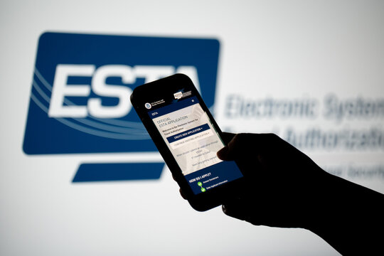 Hand holding smartphone with ESTA Electronic System for Travel Authorization website, filling form to travel to the United States under the Visa Waiver Program on February 17, 2026 in Krakow, Poland.