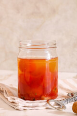 Fototapeta premium Tomato pickles for hangover remedy in a glass jar, demonstrating traditional morning recovery food and fermented vegetables