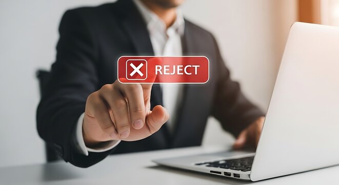 A man in a suit rejecting something on a laptop with a red reject button