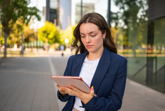 Businesswoman using digital tablet in urban city setting