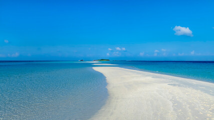 Summer lagoon Ripples in the sand at low tide on a beach with sandbar and blue sea in Maldives island