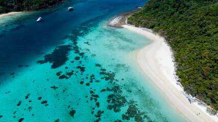Aerial view of white sand beach tropical with seashore as the island in a coral reef ,blue and turquoise sea Amazing nature landscape with blue lagoon	