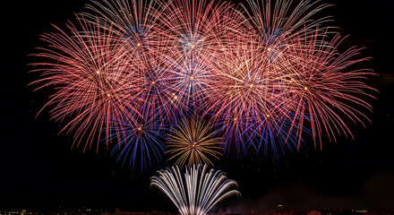 Fototapeta premium Colorful fireworks display bursting over the city skyline of Val