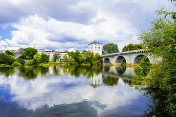 Fototapeta premium View of the old Lahn bridge and the Lahn River near Limburg an der Lahn. Landscape along the river near the town. 