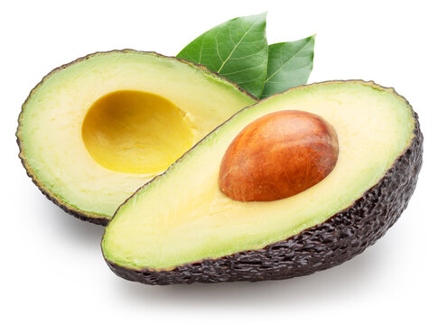 Halves of hass avocado fruits with avocado leaves isolated on white background. File contains clipping paths.