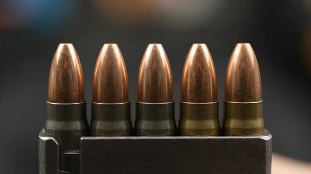 Close up of ammunition cartridges in a row with metallic appearance