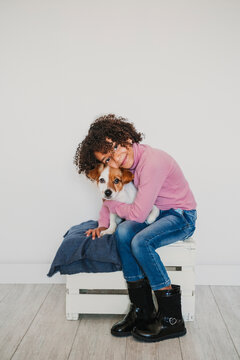 Portrait of smiling little girl cuddling her dog