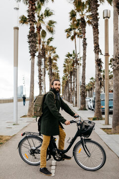Portrait of man with e-bike on a promenade