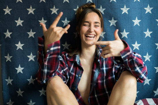 Happy young woman in front of star-shaped background