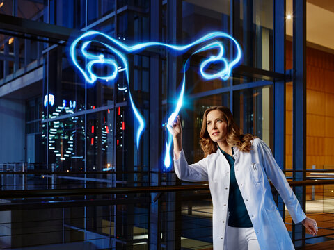 Female gynecologist light painting ovary in laboratory at hospital