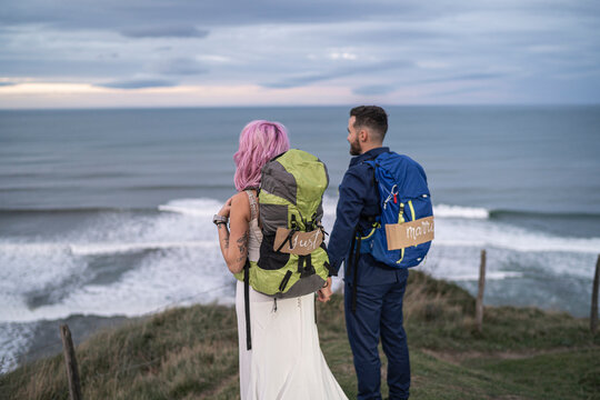 Bridal couple on viewpoint and ocean in the background