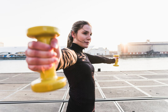Young woman exercising in the city at sunet