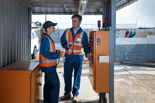 Two workers wearing overalls and reflective jackets