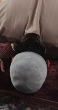 Home, prayer and bow with muslim man for religion, faith and praise Allah for gratitude. Islam, spiritual and person prostrate for praying, dua and devotion for holy worship with peace on Eid