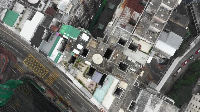 Hong Kong housing crisis - Overhead drone shot of 'rooftop slum' on top of residential apartment block in suburbs Quarry Bay