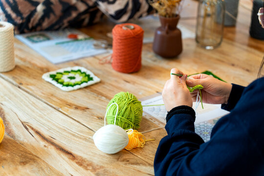 Woman crocheting a square at hobby craft club