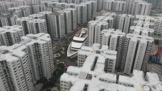 Revealing drone shot of bizarre cruise boat shaped shopping arcade and restaurant in Hong Kong
