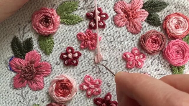 Lazy daisy stitch flower embroidery tutorial. Close-up hand stitching looped petal floral element on fabric. Step-by-step needlework technique for beginners, DIY embroidery learning . Part 1