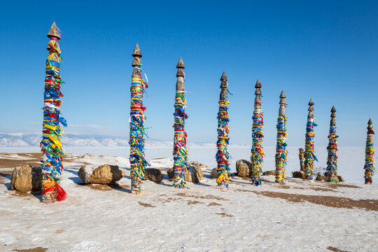 Wooden ritual pillars with colorful ribbons on cape Burkhan