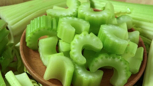 Fresh celery in a wooden bowl.	