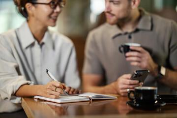 Coworkers meeting in coffee shop planning business strategy