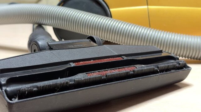 The powerful vacuum cleaner motor ceases its high-speed rotation. This action causes the intense, loud hum to descend in pitch until it settles into a final, soft mechanical click.