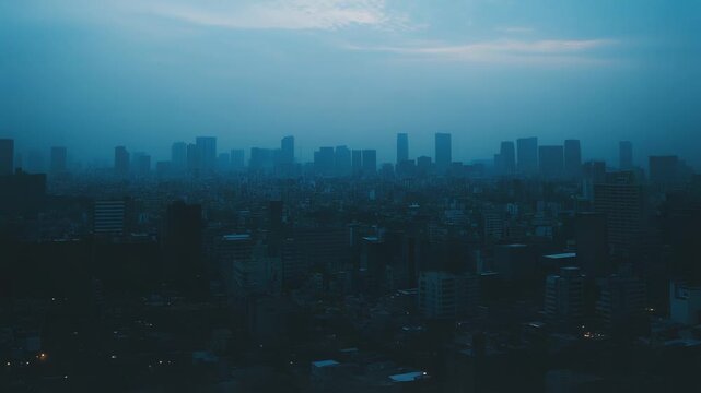 Urban skyline with high rise buildings and city architecture emerging through dense morning haze, creating a monochromatic atmospheric landscape at dawn