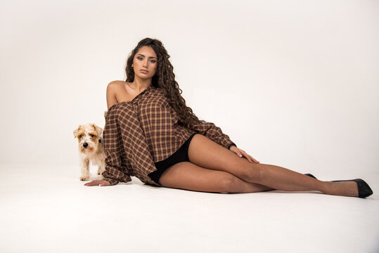Woman with dog posing in plaid shirt