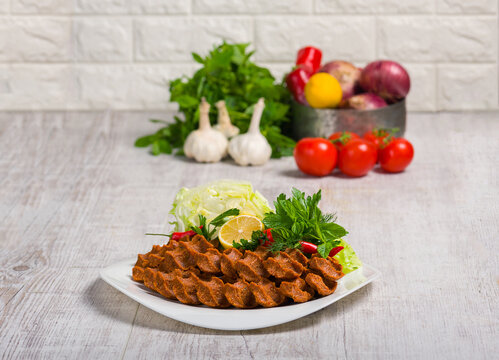 Traditional Turkish Cig kofte Platter with Fresh Greens and Lemon