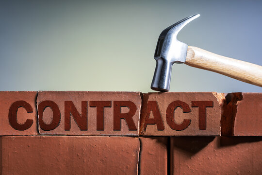 Breach, cancellation of contract concept. Hammer breaking a contract brick.