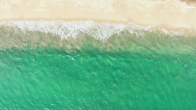 Beautiful sea summer landscape, Waves sea water surface High quality video Bird's eye view, Drone top view waves crashing on sand beach,Nature ocean sea beach background