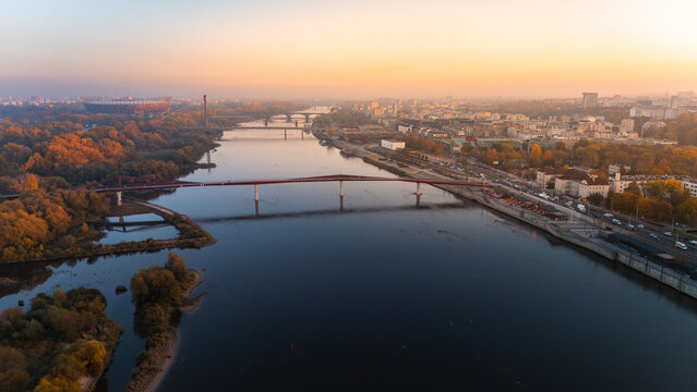 An aerial view of the Vistula River overlooking Warsaw's Old Town in Poland during the autumn sunset