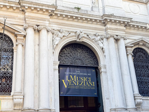 Venice, Italy - February 17, 2026: Architectural detail of a historic building entrance featuring ornate columns and a banner for L Musici Veneziani in Venice, Italy