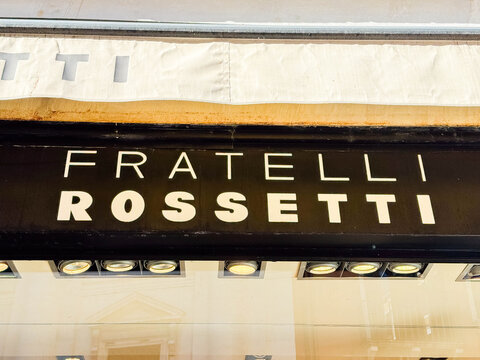 Venice, Italy - February 17, 2026: Fratelli Rossetti storefront sign featuring bold lettering and illuminated display lights in a retail shopping area