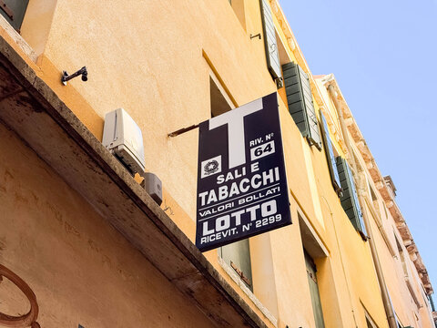 Venice, Italy - February 17, 2026: Sign for "Sali e Tabacchi" shop displaying lottery and tobacco services on a yellow building in a European city