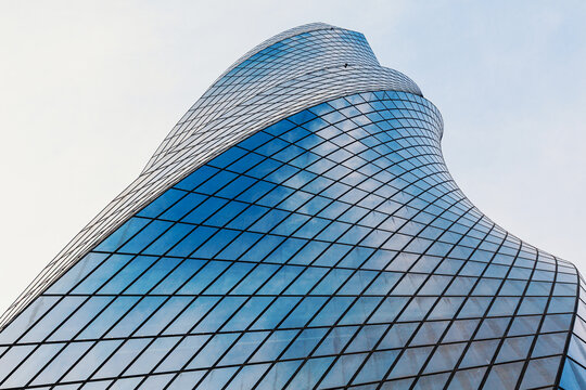 Modern glass facade featuring abstract curves and geometric patterns