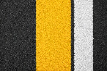 Fototapeta premium Textured asphalt surface featuring bold yellow and white lines creating visual depth and highlighting the importance of road safety and urban navigation