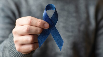 male hand hold blue ribbon prostate cancer health care concept
